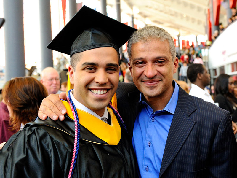 Photo of a student and a man smiling
