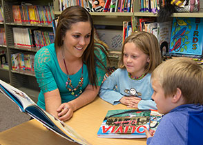 Photo of a student reading to children. Link to Gifts That Protect Your Assets